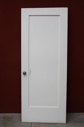 White door against a red wall.