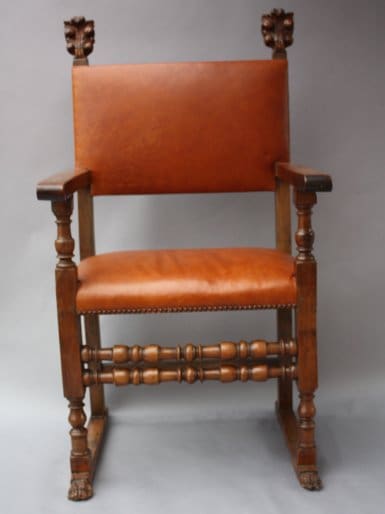Antique wooden chair with leather seat.