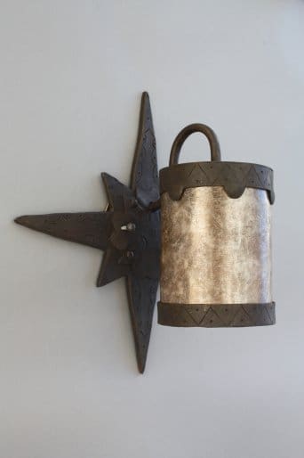 Metal wall sconce with star design.