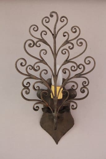 Decorative wrought iron wall sconce design.