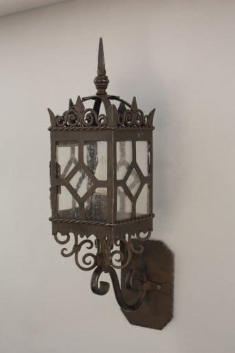 Decorative wall-mounted lantern with glass panes.