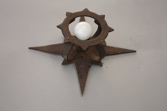 Decorative wall sconce with a light bulb.