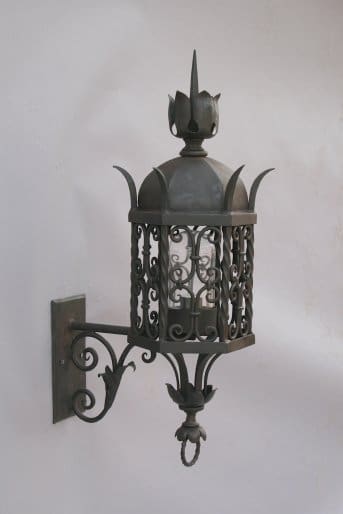 Ornate wall-mounted metal lantern design.