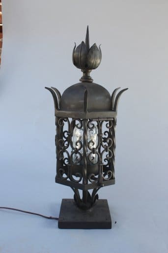 Decorative black metal lantern with floral design.