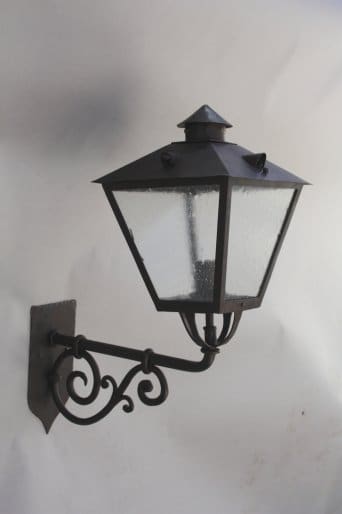 Wall-mounted decorative lantern with glass panels.