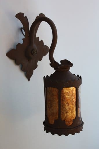 Vintage wall lantern with ornate design.