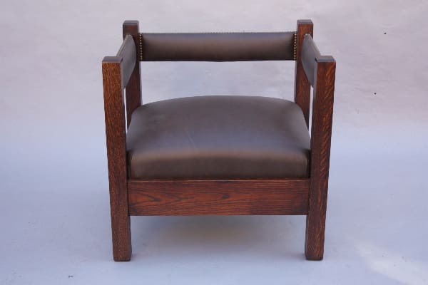 A dark wooden 8814. Arts And Crafts Mission Cube Chair with a leather cushion and visible grain texture, set against a neutral gray background.