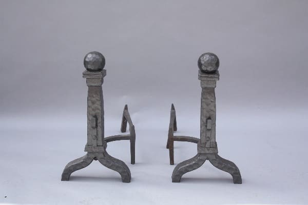Two 9293. 1920's Spanish Revival Cast Iron Andirons with ball finials and arched legs on a gray background.