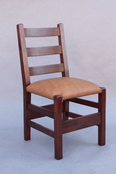 A 9800. 1910 Arts & Crafts Ladder Back Chair with a brown leather cushion and horizontal slat backrest against a neutral background.