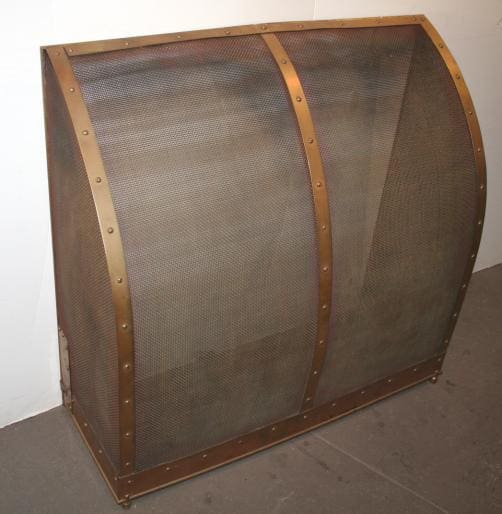 A large, curved, 994. Free Standing Fireplace Screen secured with horizontal wooden strips and metallic rivets, displayed against a plain wall and floor.