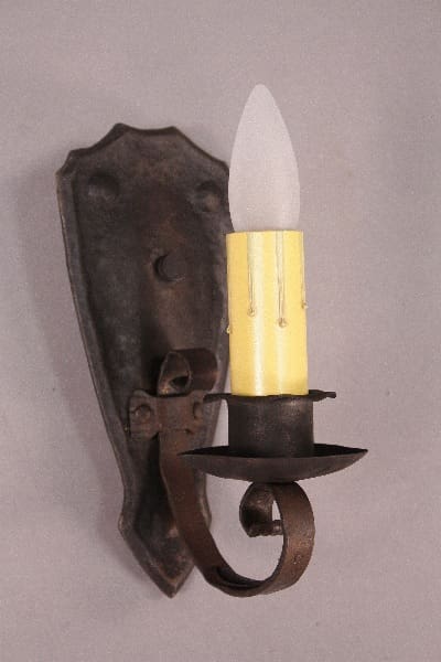 Vintage wall sconce with candle-style bulb.