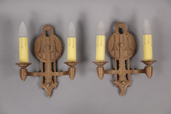 Ornate wall sconces with candle bulbs.