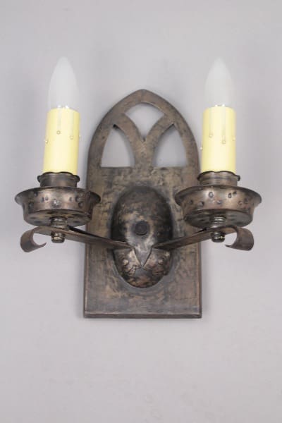 Ornate metal two-light wall sconce.