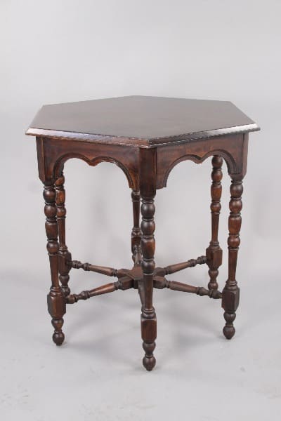 Dark wood hexagonal table with intricate legs.