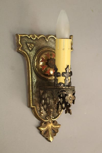 Ornate gold wall mounted candle sconce.