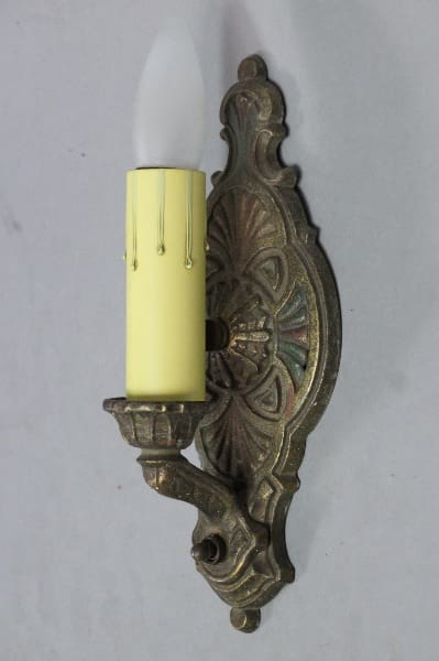 Ornate wall-mounted candle light fixture.
