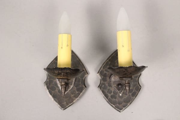 Two wall sconces with candle-like bulbs.