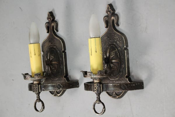 Vintage candle wall sconces with yellow candles.