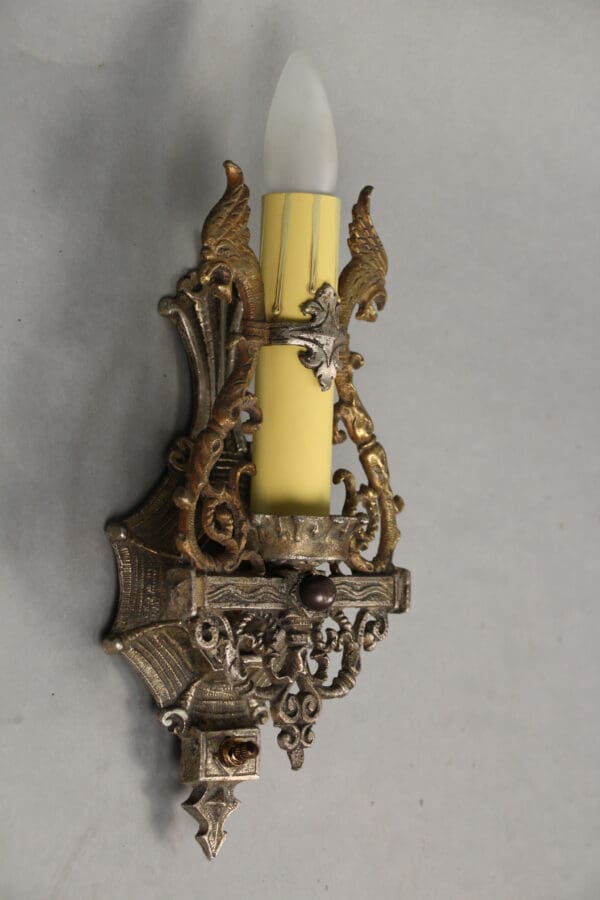 Decorative wall sconce with candle design.