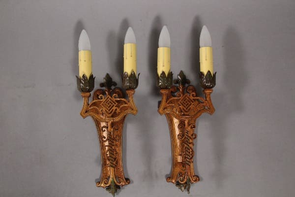 Ornate wall sconces with candle-like bulbs.