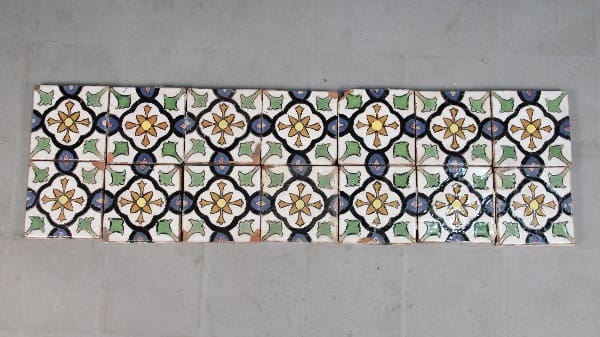 A row of decorative ceramic tiles with floral designs.