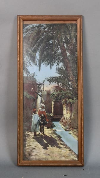 Framed painting of people in a desert landscape.