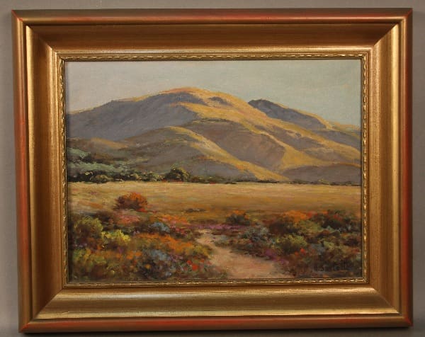 Mountain landscape painting in golden frame.