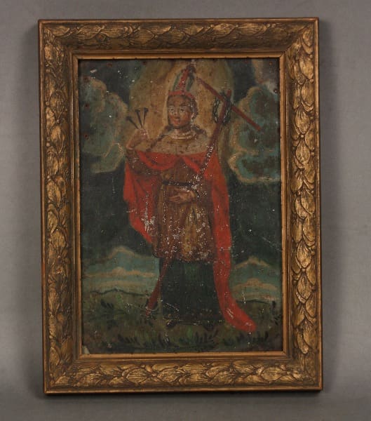 Historic figure in ornate frame, holding symbols.