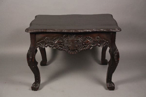 Ornate wooden table with carved legs.