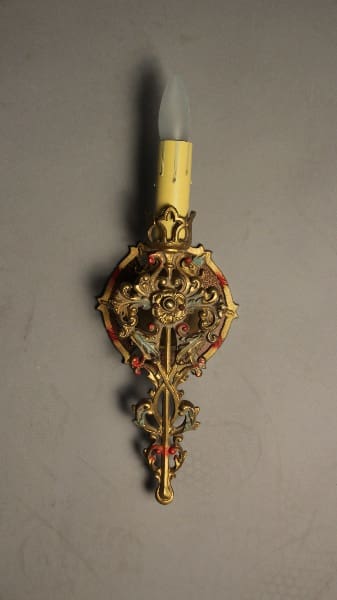 Ornate wall sconce with decorative design.