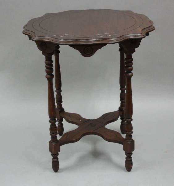 Ornate wooden table with carved legs.