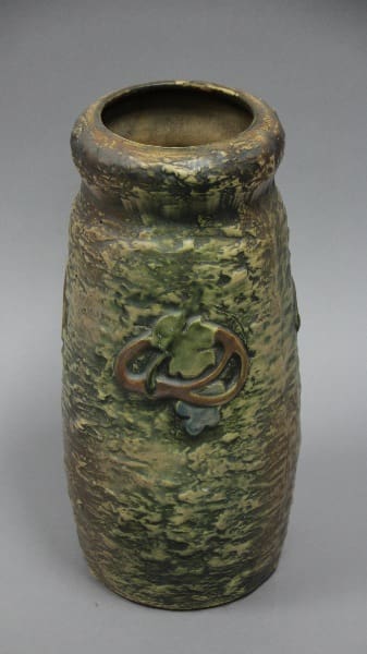 Ornate ceramic vase with leaf design.