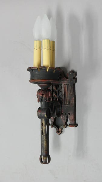 Vintage wall sconce with three candle lights.