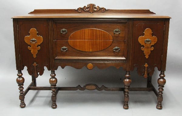 Antique wooden sideboard with ornate details.