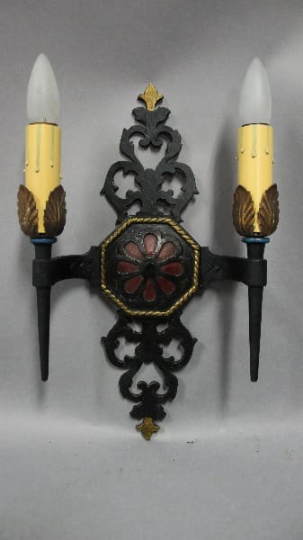 Ornate wall sconce with candle holders.