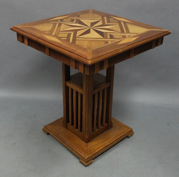 Wooden table with geometric inlay top.