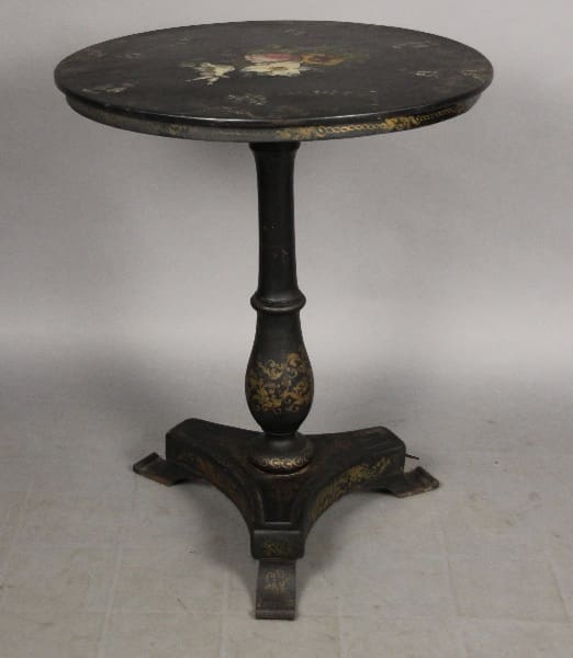 Black round table with gold painted details.