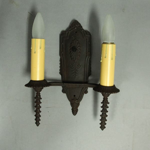 Vintage wall sconce with two candle holders.