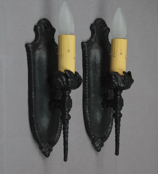 Two vintage wall sconces with candle bulbs.