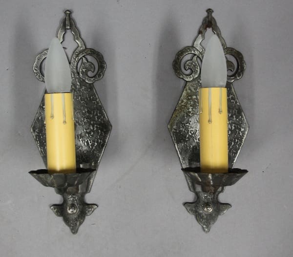 Two candle sconces with faux candles.