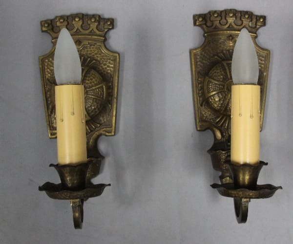 Two vintage wall sconces with candle lights.