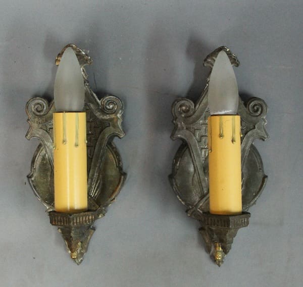 Two vintage wall sconces with candle lights.