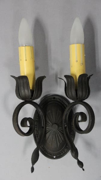 Wall-mounted candle holder with yellow bulbs.
