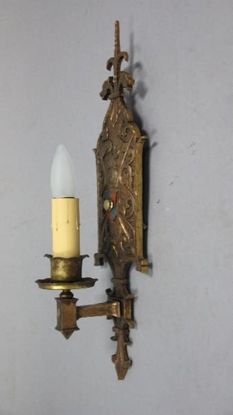 Vintage wall sconce with ornate design.