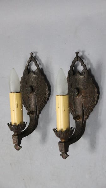 Antique wall sconces with candle-like bulbs.
