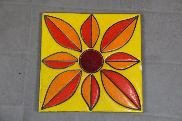 Yellow tile with a red and orange flower.