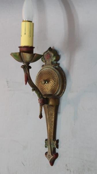 Vintage wall sconce with decorative design.
