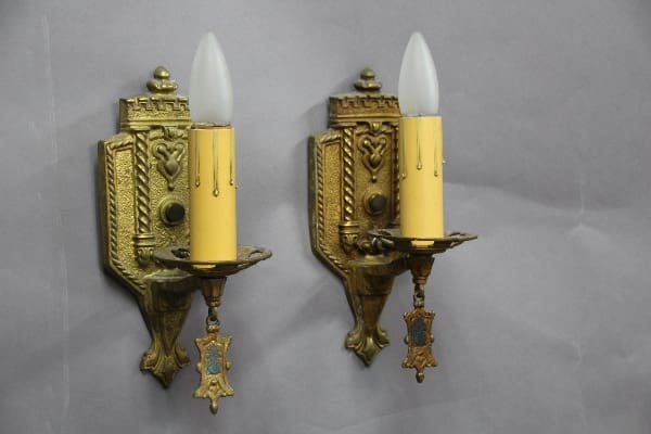 Two vintage-style candle wall sconces.