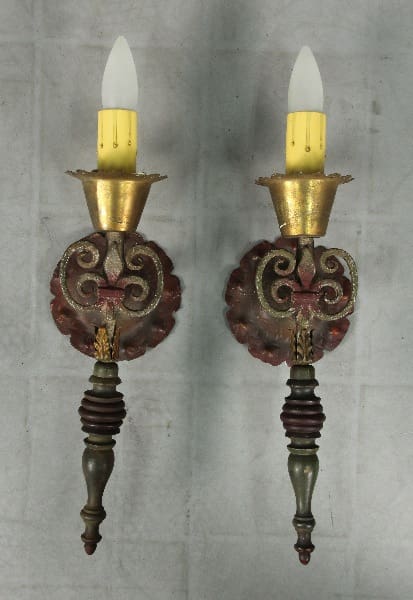 Two vintage wall sconces with candles.