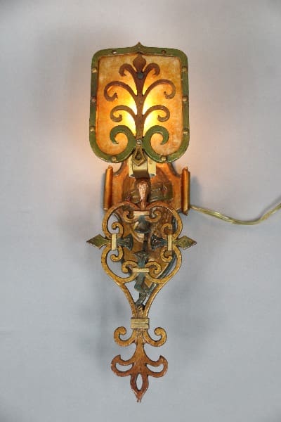 Vintage wall sconce with ornate design.